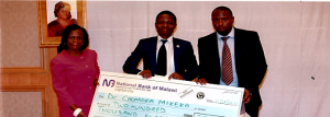 NCST Director General-Anthony Muyepa (right) and Head of Documentation and Information Services Gift Kadzamira (left) presents the cheque to Dr Mikeka (middle)