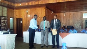 Dr. Monjerezi Receiving his certiicate from the Deputy Minister of Education, Science and Technology, Vincent Ghambi, MP. (1)