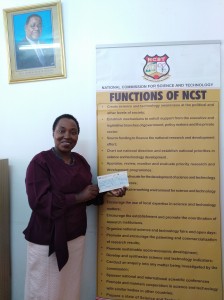 Mrs Kazembe happily showing off her grant